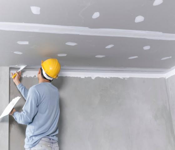 worker plastering ceiling