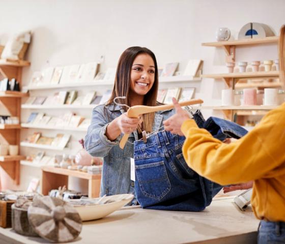 lady customer buying jeans from retail assistant