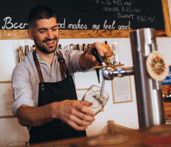 man pouring a beer