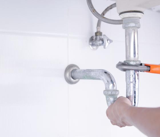 Plumber working in bathroom