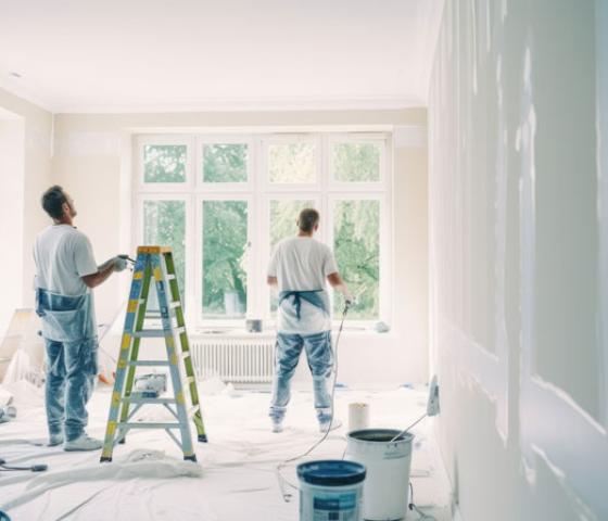 two men painting a room