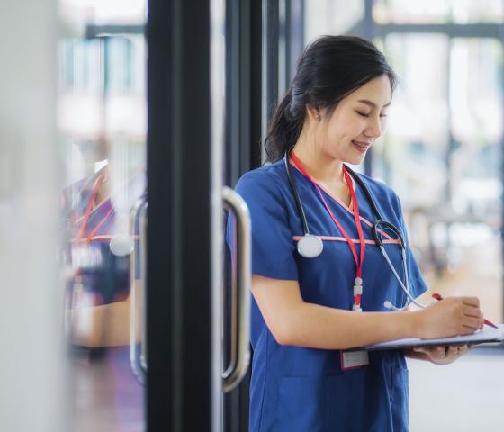 Nurse checking chart