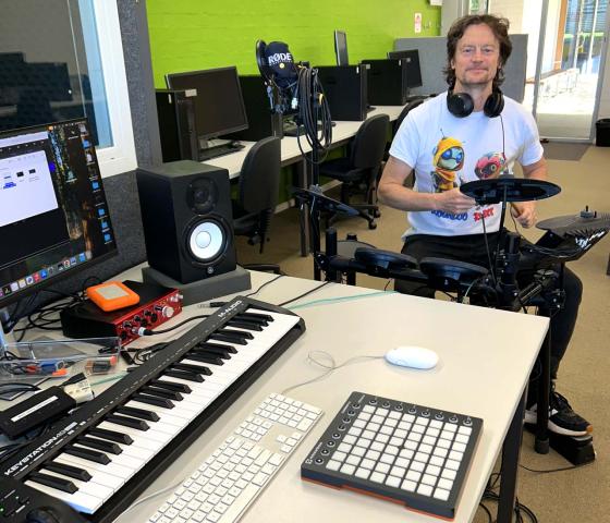 TAFE Music lecturer playing an electronic drum kit