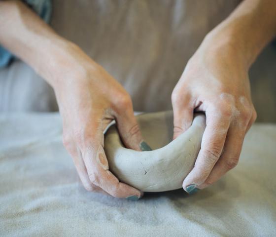 person working with clay